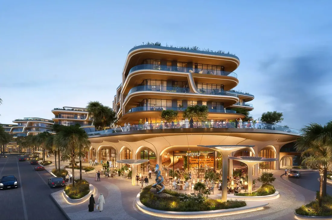 The Grove facade at dusk with illuminated retail colonnade below sweeping balconies