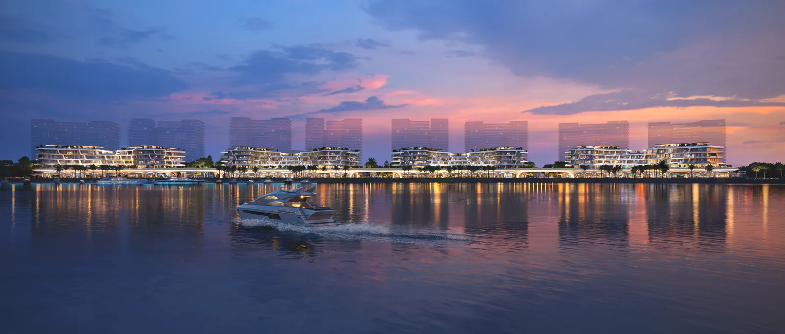 The Grove at dusk seen across the water on Qetaifan Island North, lit along the shoreline with a yacht approaching